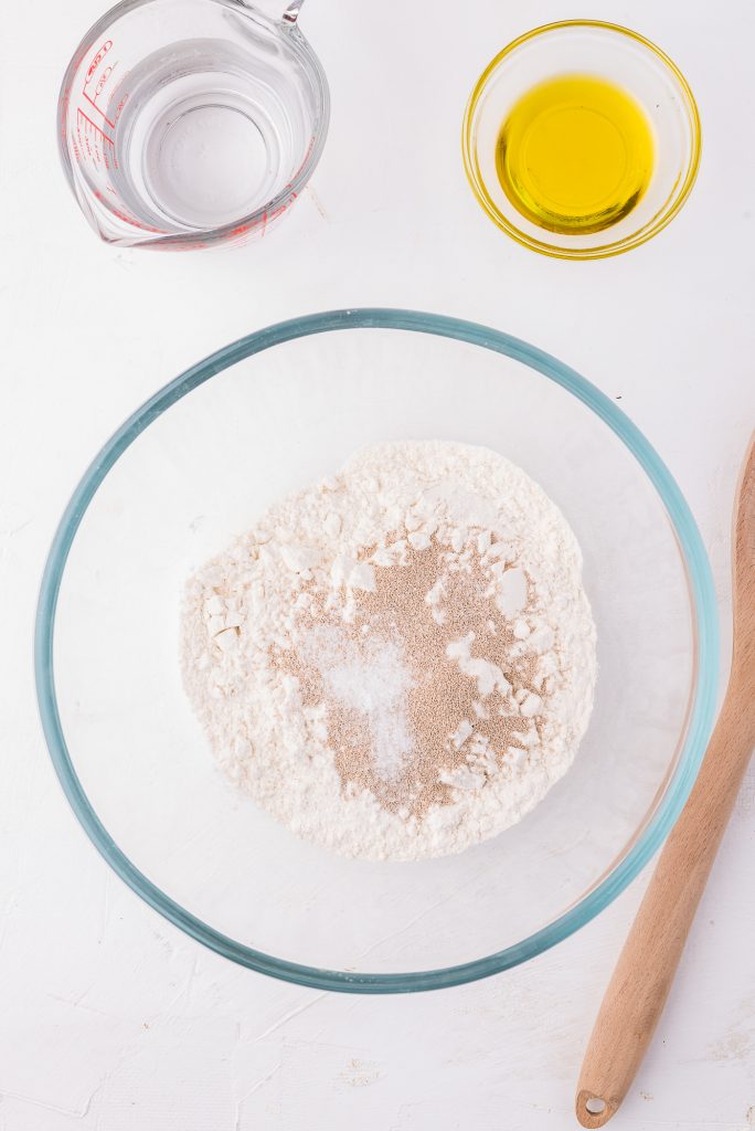 A glass bowl with the dry dough ingredients.