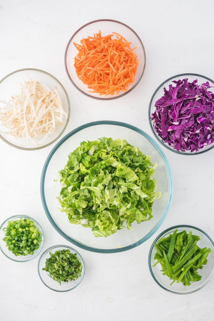 The ingredients for the salad base each in a small glass bowl.