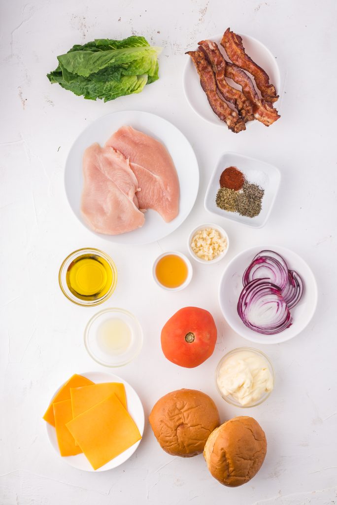 A mis-en-place of the ingredients needed to make a Grilled Chicken Sandwiches with Garlic Aioli.