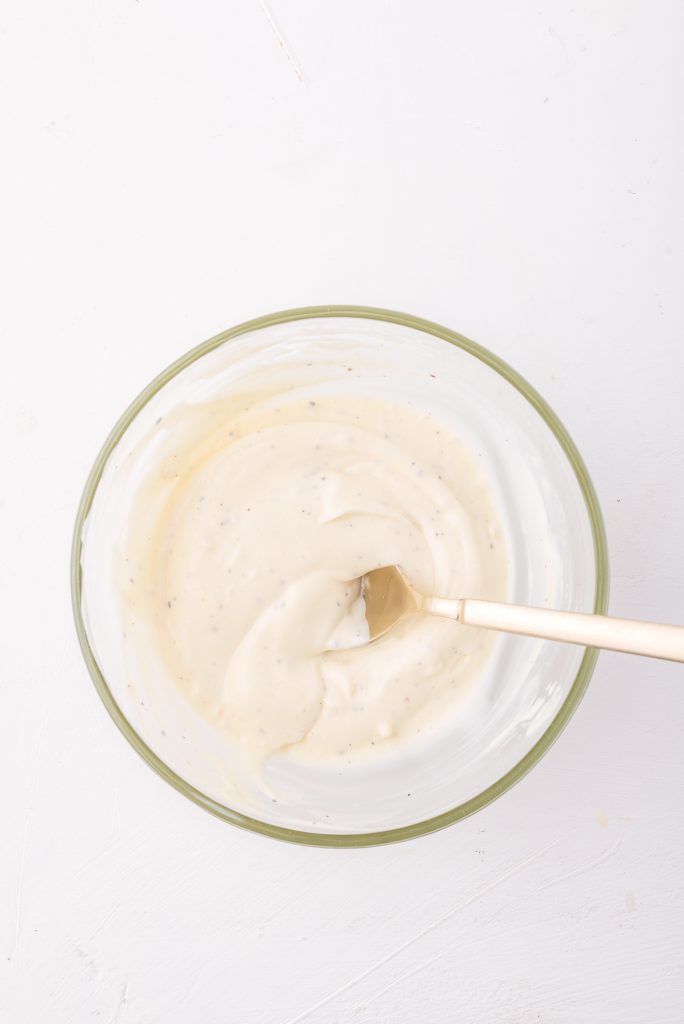 A glass bowl of garlic aioli.