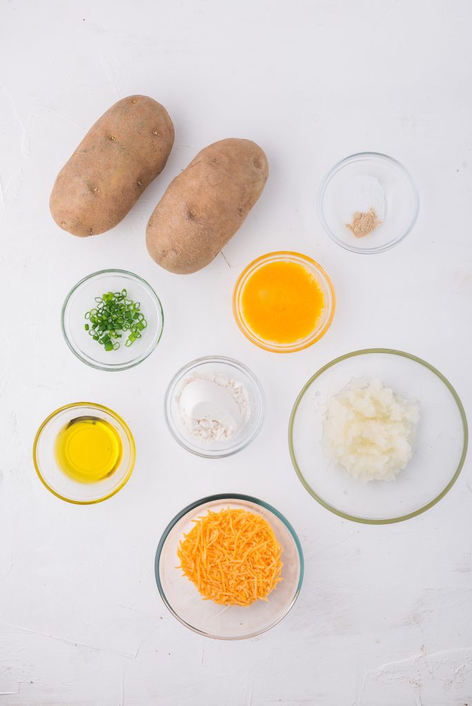 A mis-en -place of the ingredients needed for Cheesy Potato and Onion Breakfast Pancakes.