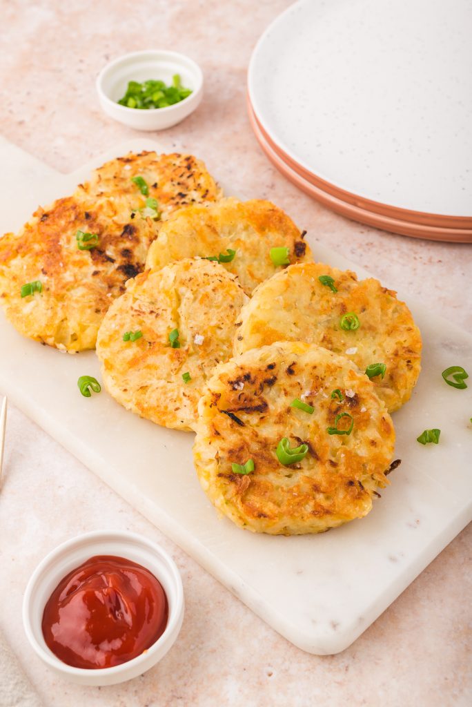 A plate of six Cheesy Potato and Onion Breakfast Pancakes