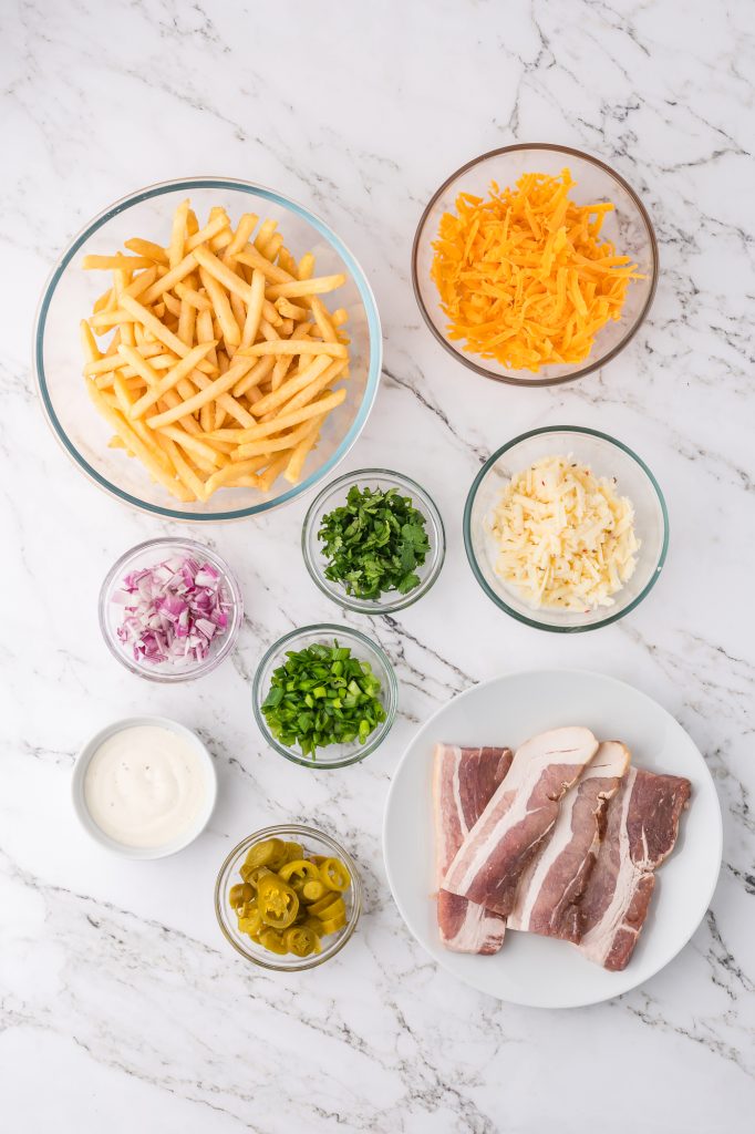 A mis-en-place of the ingredients for Loaded Cheese Fries.