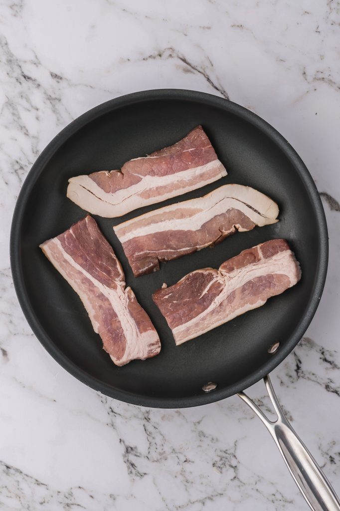 Raw bacon in a pan.