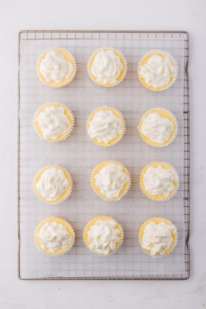 The cooled Mini Cheesecake Bites topped with whipped cream.