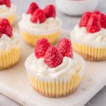 Five Mini Cheesecake Bites site on a marble serving board.