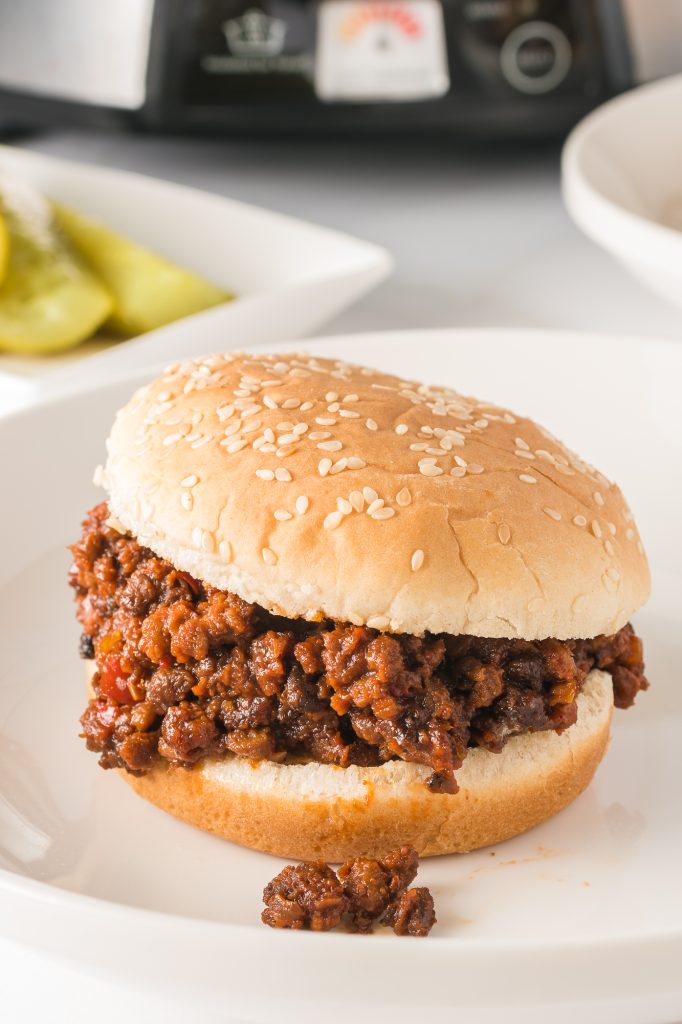 A completed slow cooker sloppy joe on a white plate.