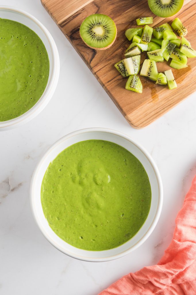 A white bowl full of the Tropical Green Smoothie Bowl base.