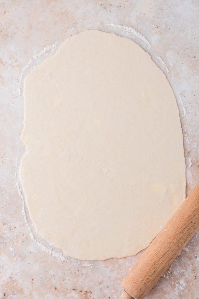 Rolled out dough on a counter.