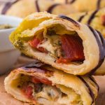 A close-up of two stacked halves of a Caprese Empanada.