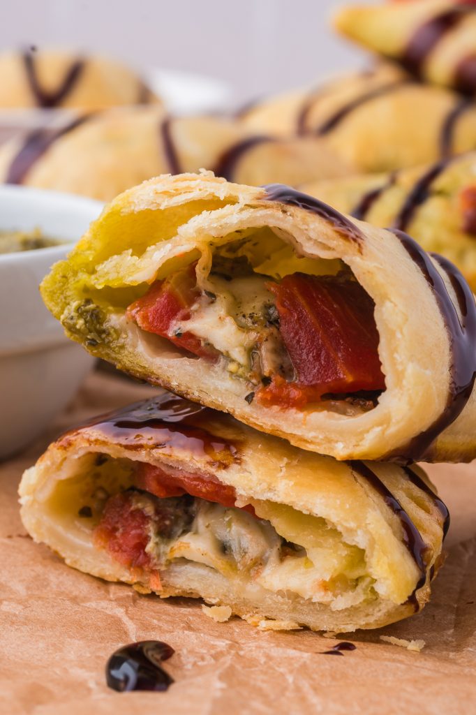 A close-up of two stacked halves of a Caprese Empanada.