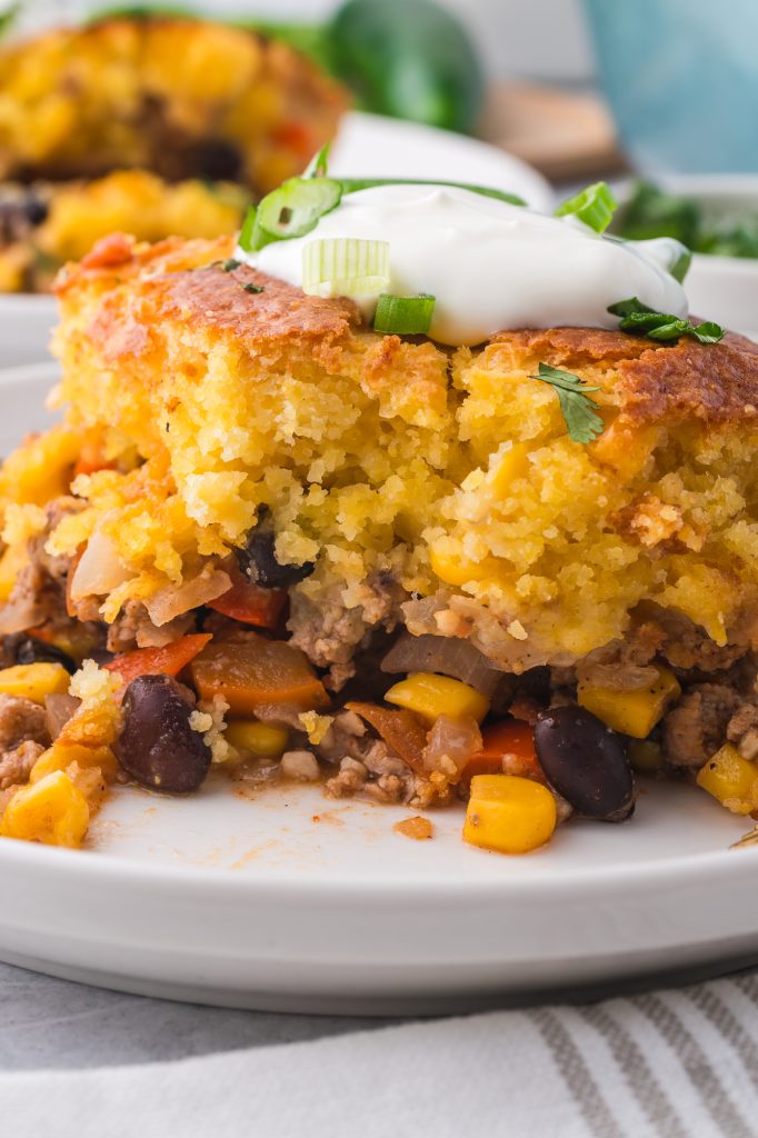 A close up of a slice of Jiffy Mexican Cornbread Casserole.