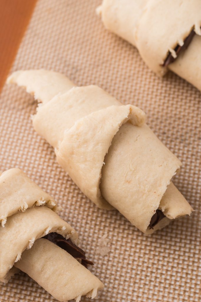 A raw Nutella Croissant crescent on a mat.