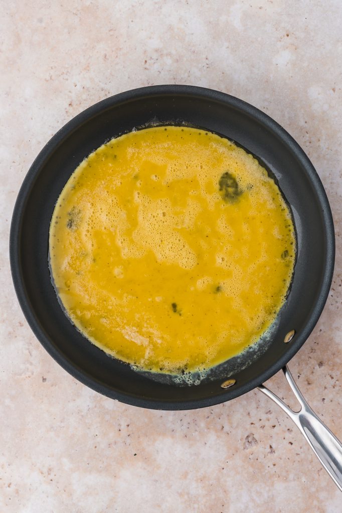 A pan with the beaten eggs in it.