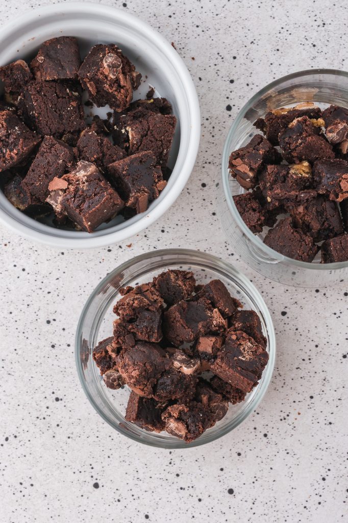 Three bowls of brownie chunks.