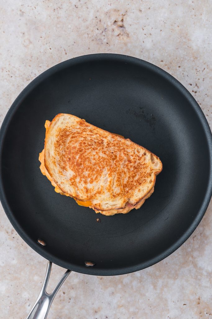 The Pimento Grilled Cheese Sandwich grilling in a pan.