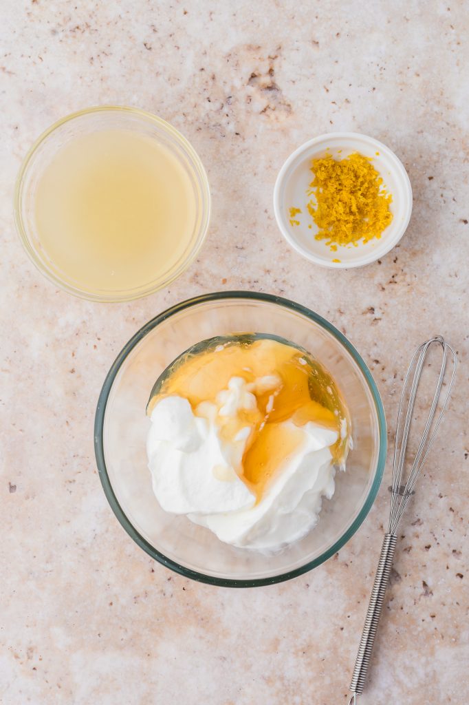 The ingredients for the Honey Lemon Yogurt sauce being mixed in a bowl.