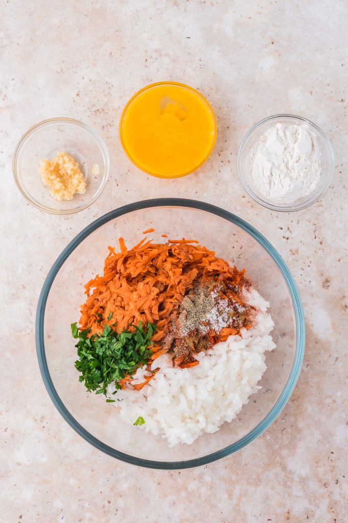 The ingredients for the Sweet Potato Fritters separted in a glass bowl.