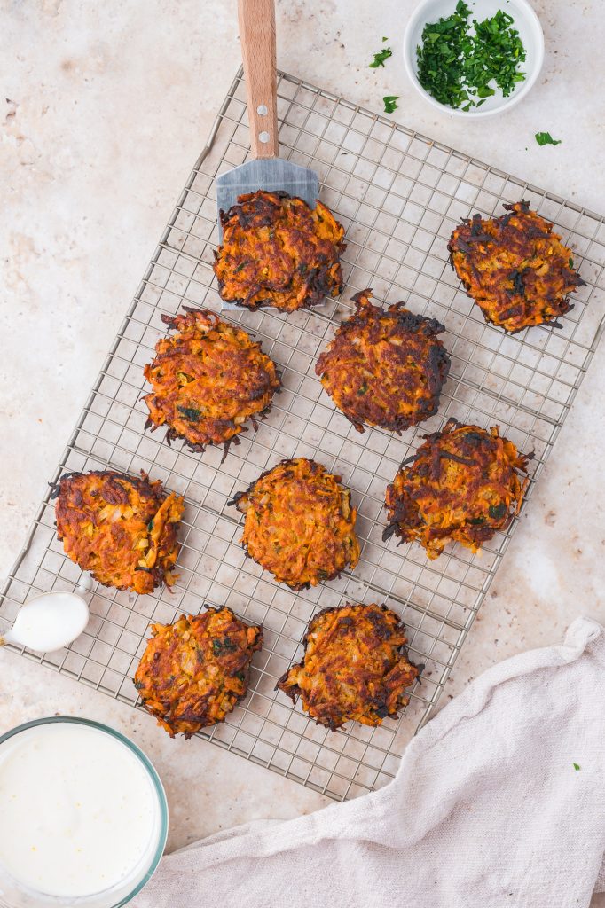 Nine Sweet Potato Fritters cooling on a cooling rack.