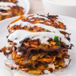 A stack of Sweet Potato Fritters with Honey Lemon Yogurt Sauce.