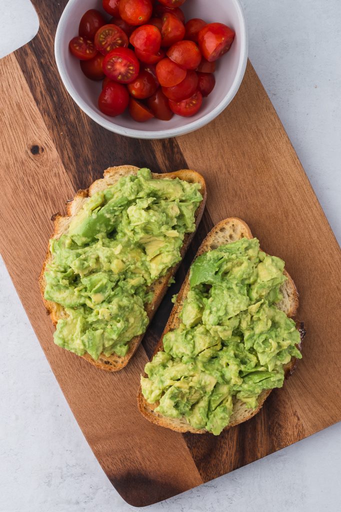 Two slices of toast spread with mashed avocado.