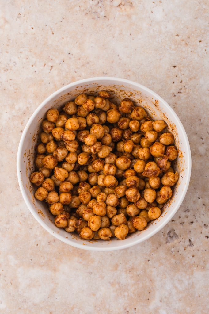 All the ingredients for Crispy Air Fryer Chickpeas mixed in a bowl.