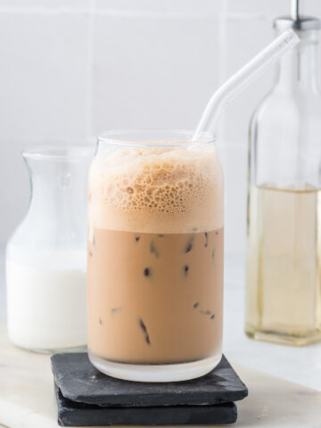 A Double Shot Iced Shaken Espresso in a glass with a glass straw.