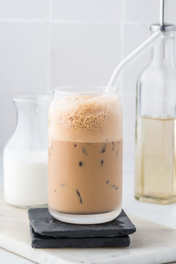 A Double Shot Iced Shaken Espresso in a glass with a glass straw.