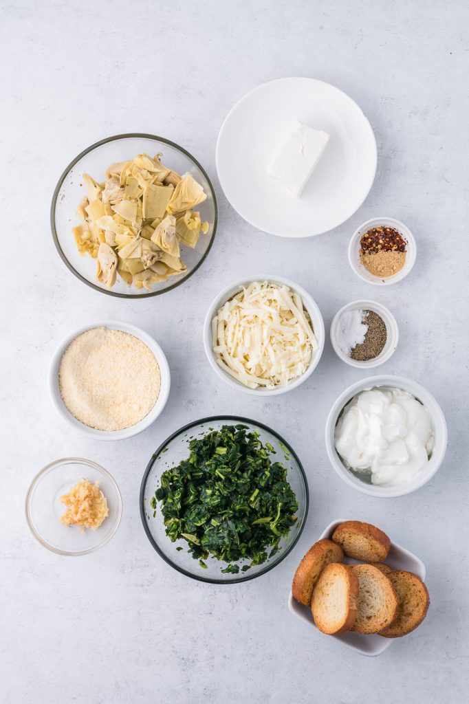 A mis-en-place of the ingredients for No Mayo Spinach Artichoke Dip.