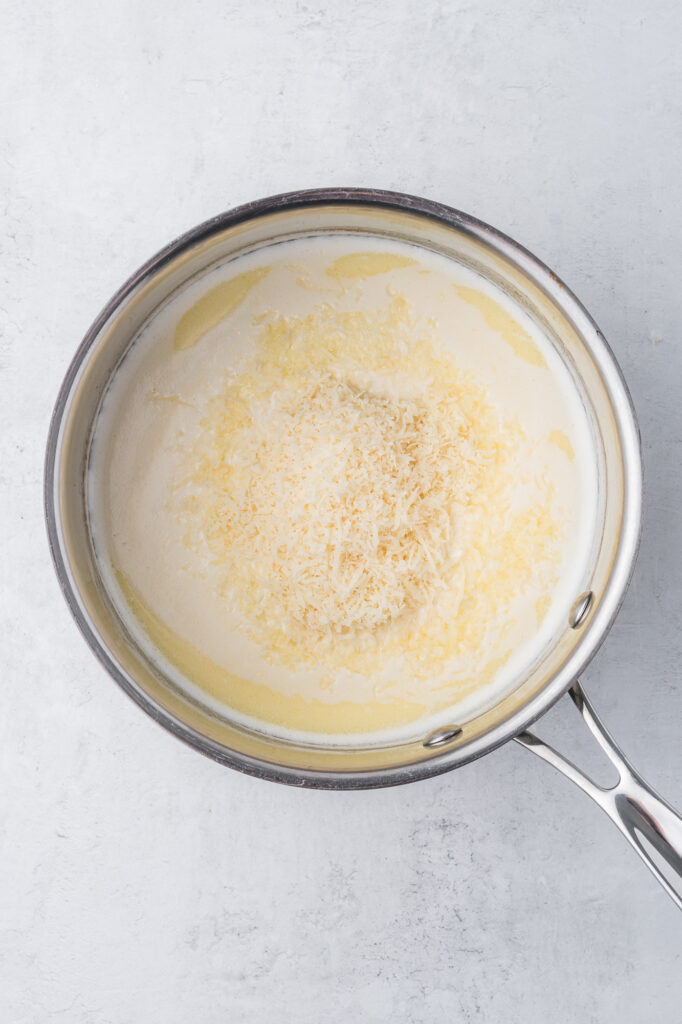 The Alfredo sauce coming together in a saucepan.