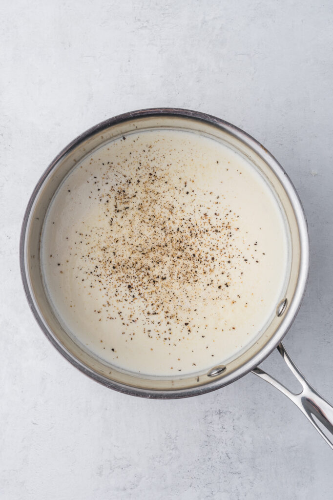 The peppered Alfredo sauce coming together in a saucepan.