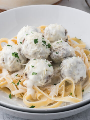 Alfredo and Meatballs over fettuccine pasta.