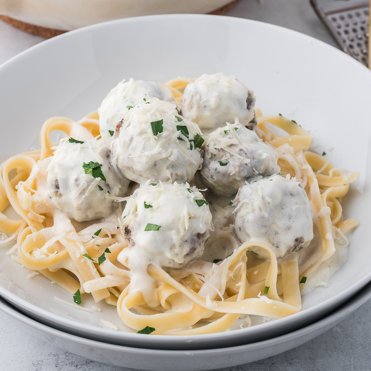 Alfredo and Meatballs over fettuccine pasta.