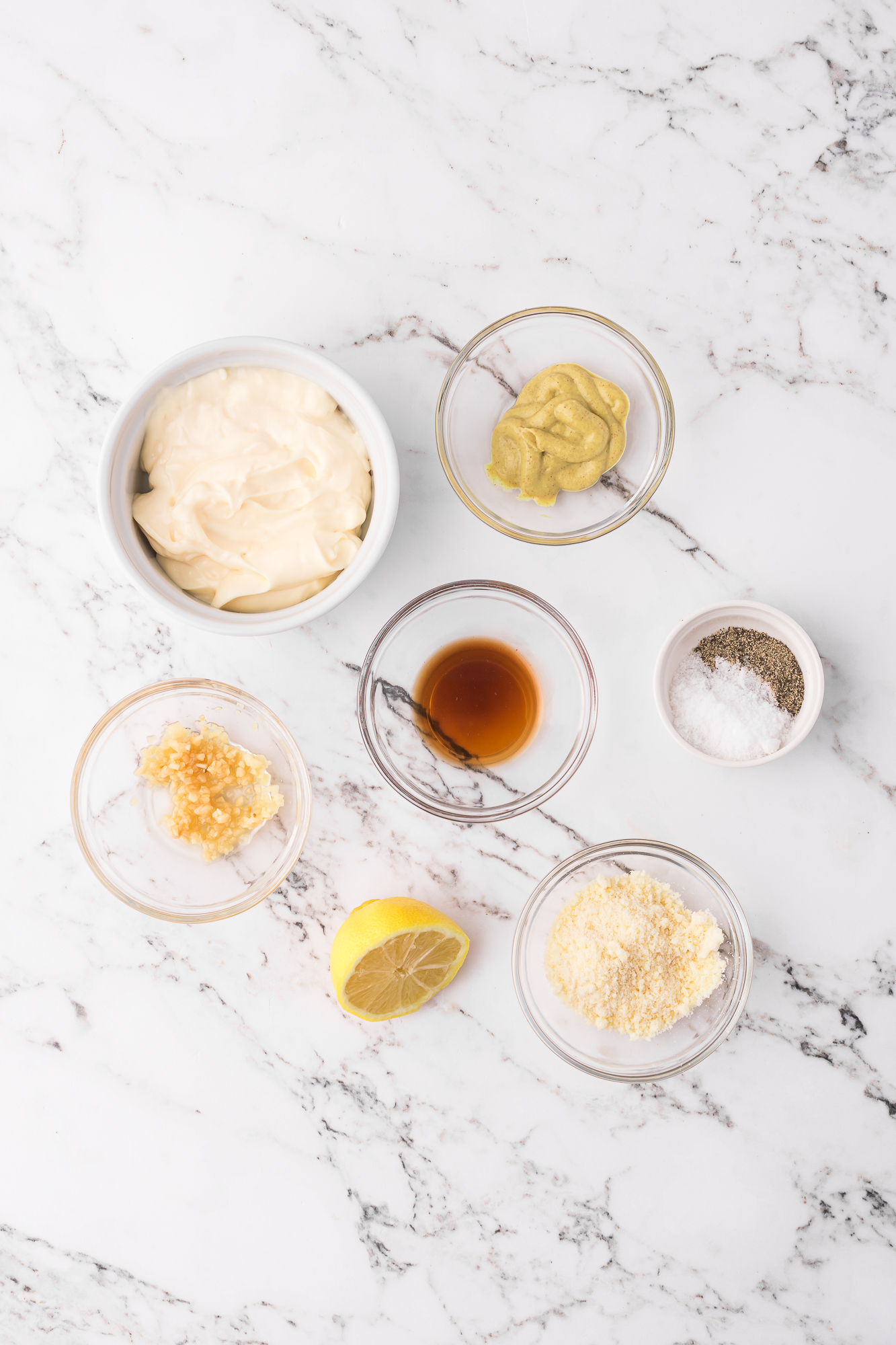 A mise en place of ingredients for Homemade Caesar Dressing.