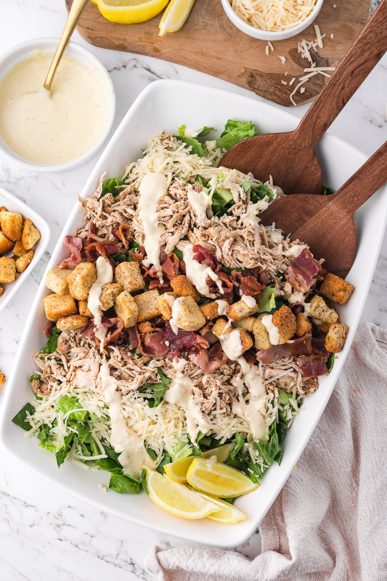 A large bowl of Chicken Bacon Caesar Salad.