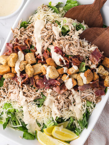 A large bowl of Chicken Bacon Caesar Salad.