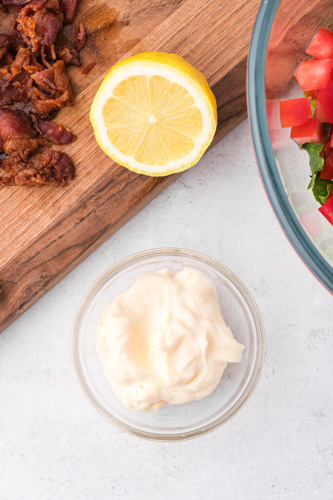 Some mayonnaise in small glass bowl.