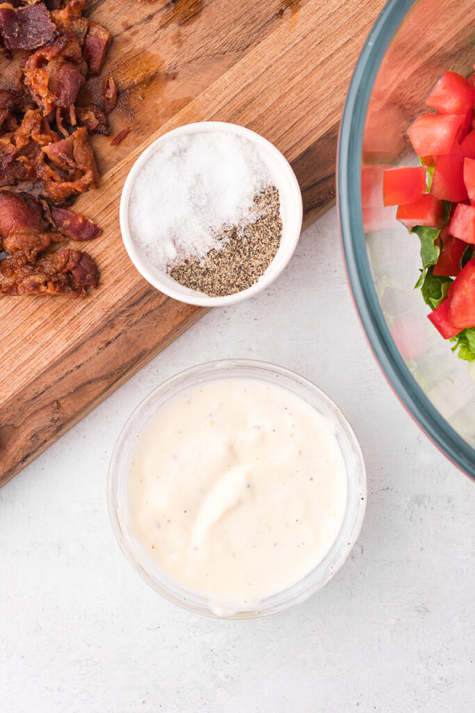 Some seasoned mayo in a small glass bowl.