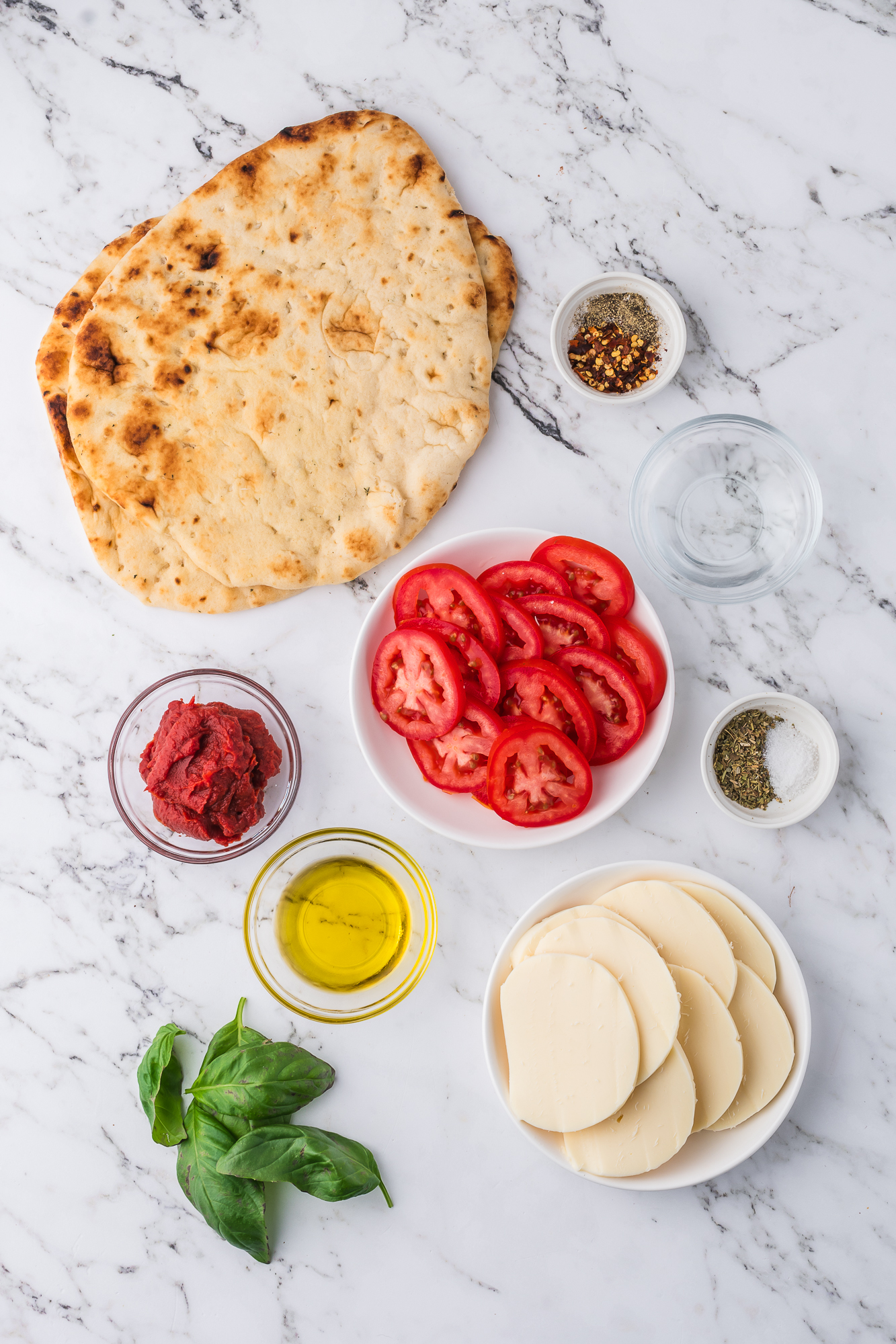 A mis en place of the ingredients for Margherita Flatbread.