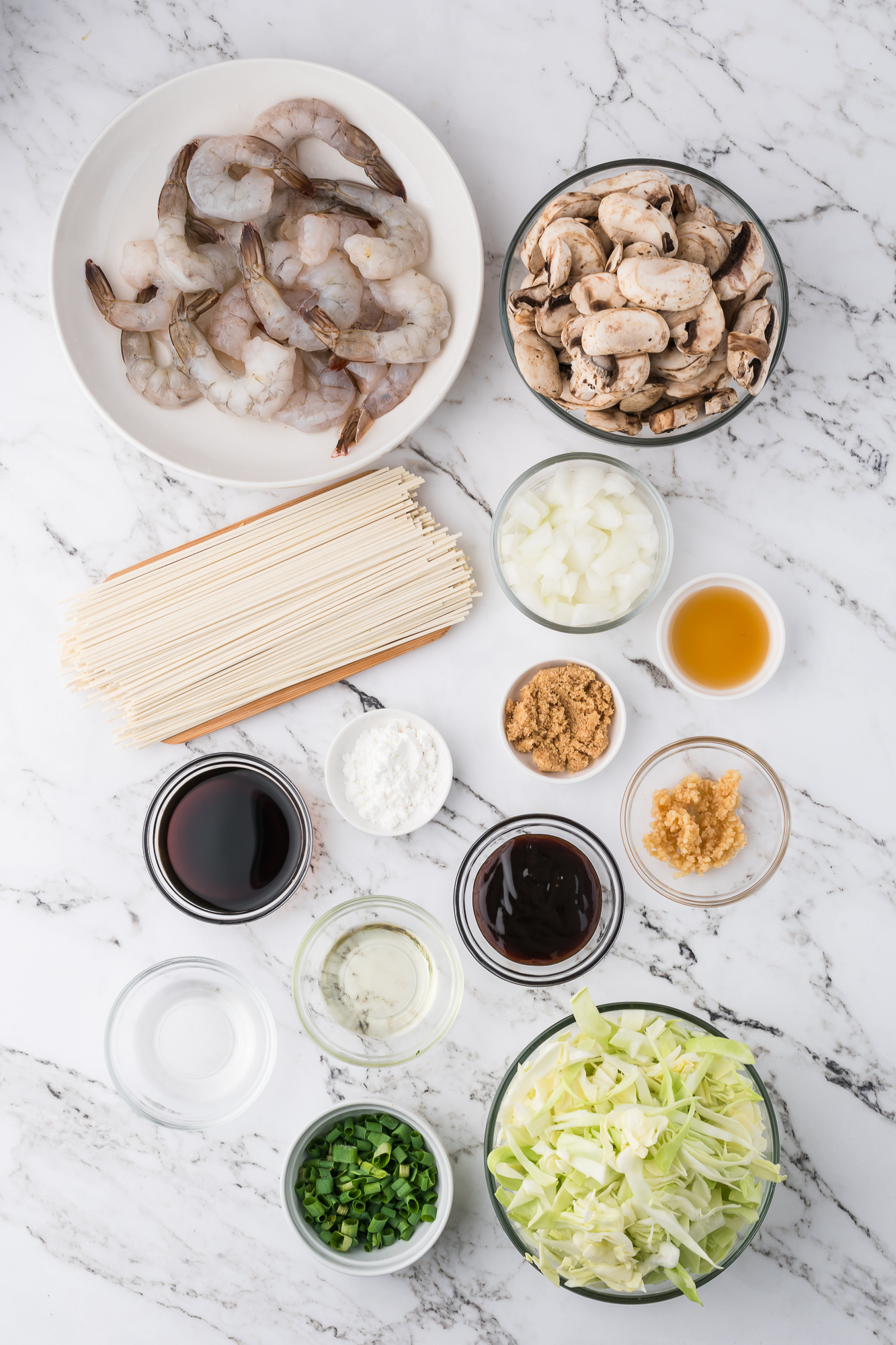 A mis en place of the ingredients for Shrimp Chow Mein.