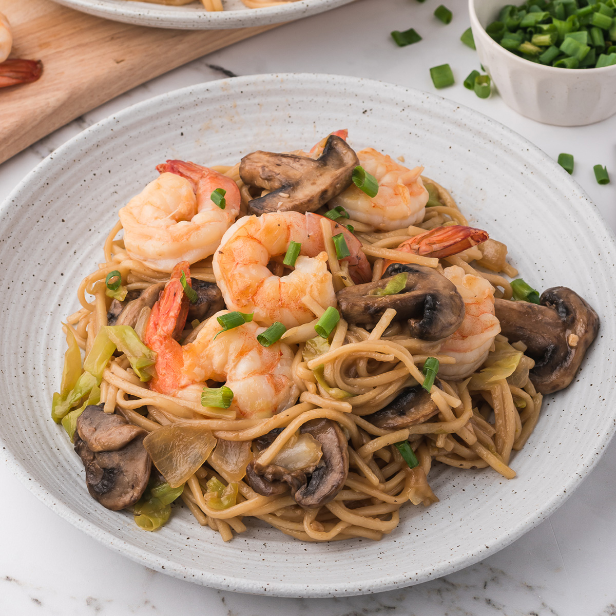 A white ceramic bowl of Shrimp Chow Mein.