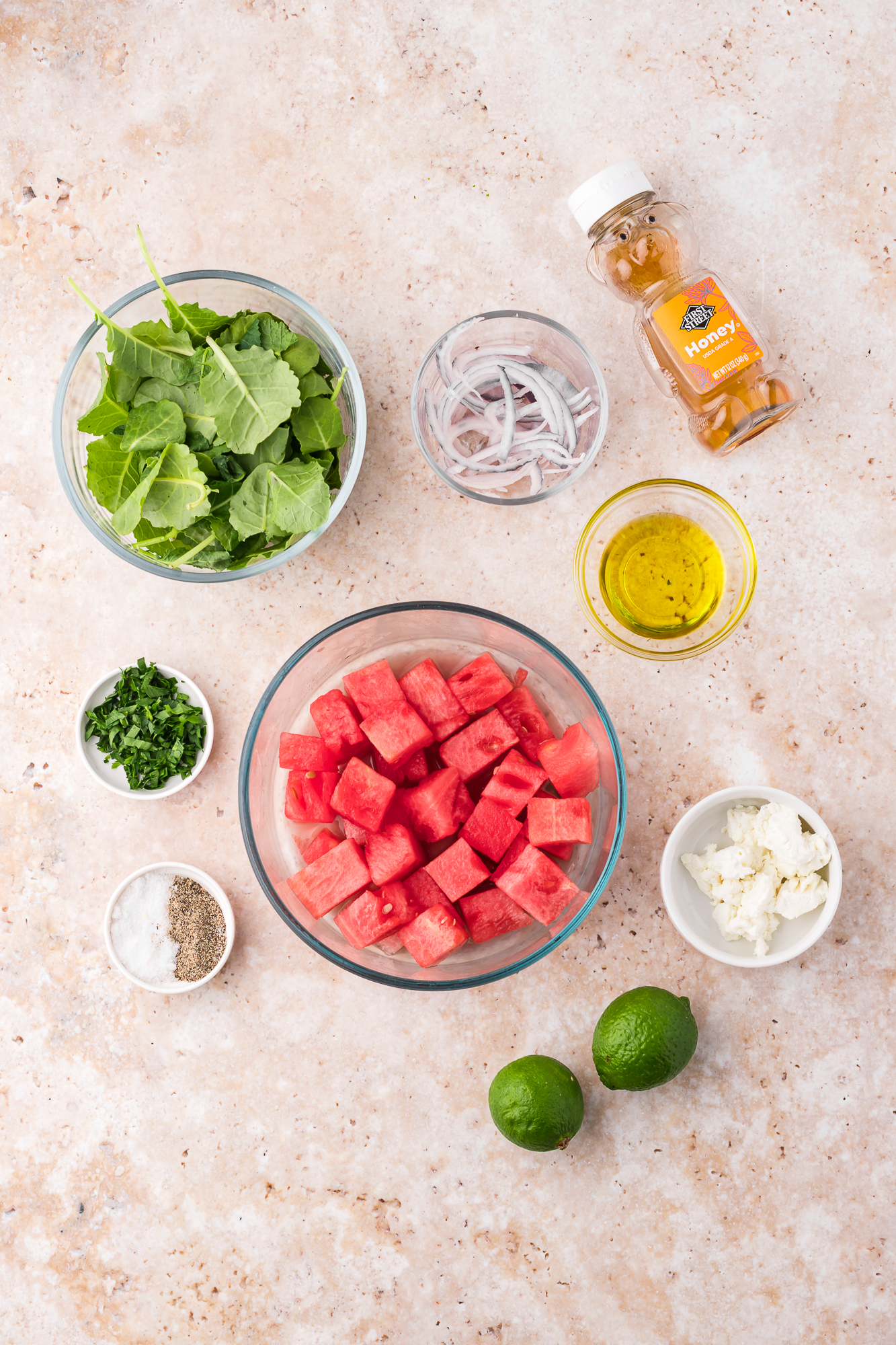 A mise en place of ingredients for a Watermelon Goat Cheese Salad.