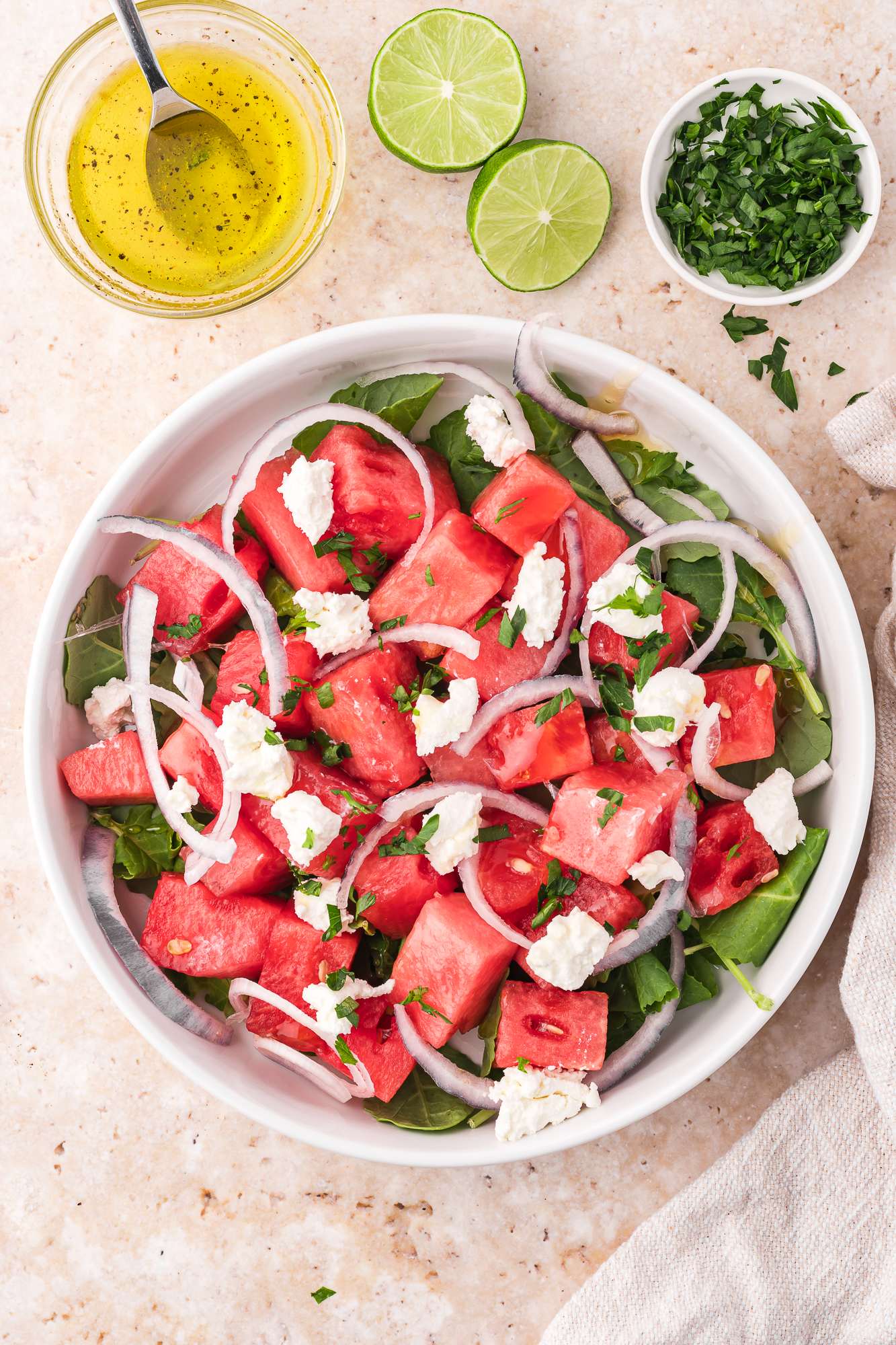 A white bowl containing Watermelon Goat Cheese Salad.