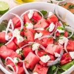 A white bowl containing Watermelon Goat Cheese Salad.