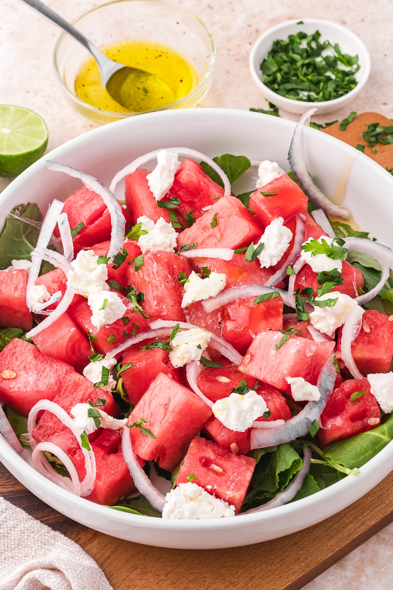 A white bowl containing Watermelon Goat Cheese Salad.