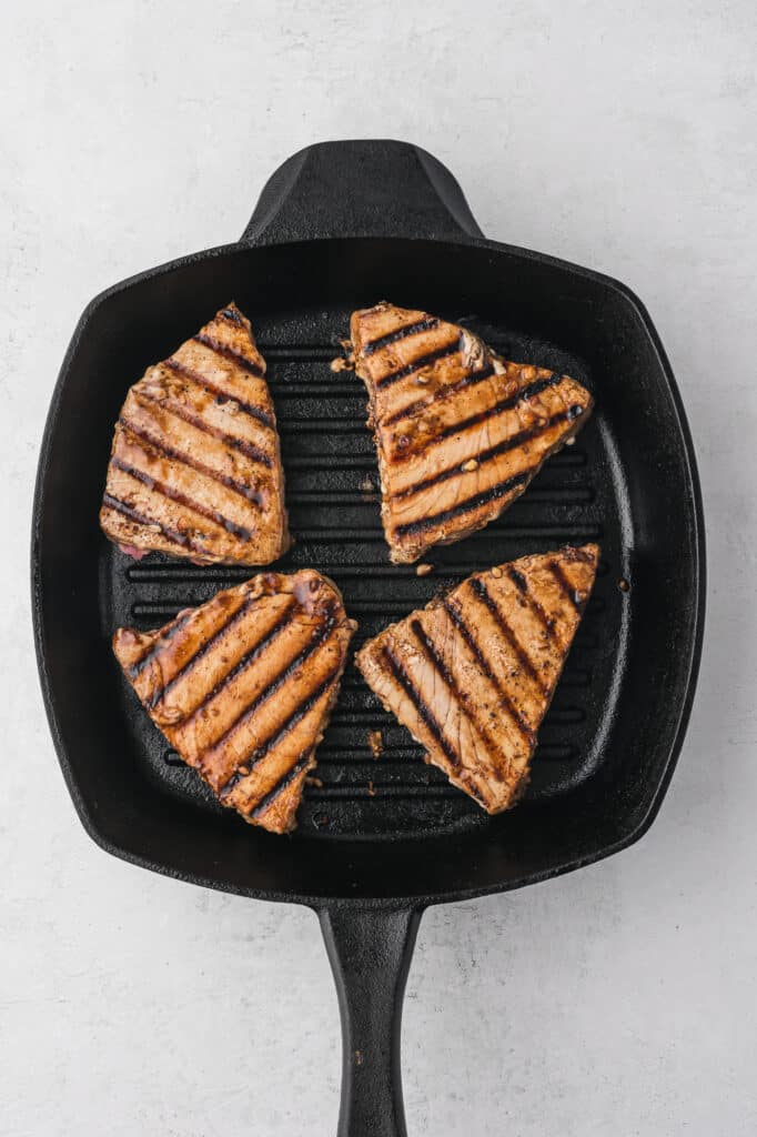 Four Grilled Tuna Steaks on the skillet.