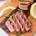 Sliced Grilled Tuna Steak on a wooden cutting board.