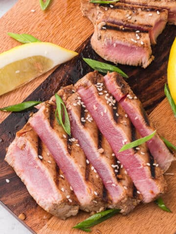 Sliced Grilled Tuna Steak on a wooden cutting board.