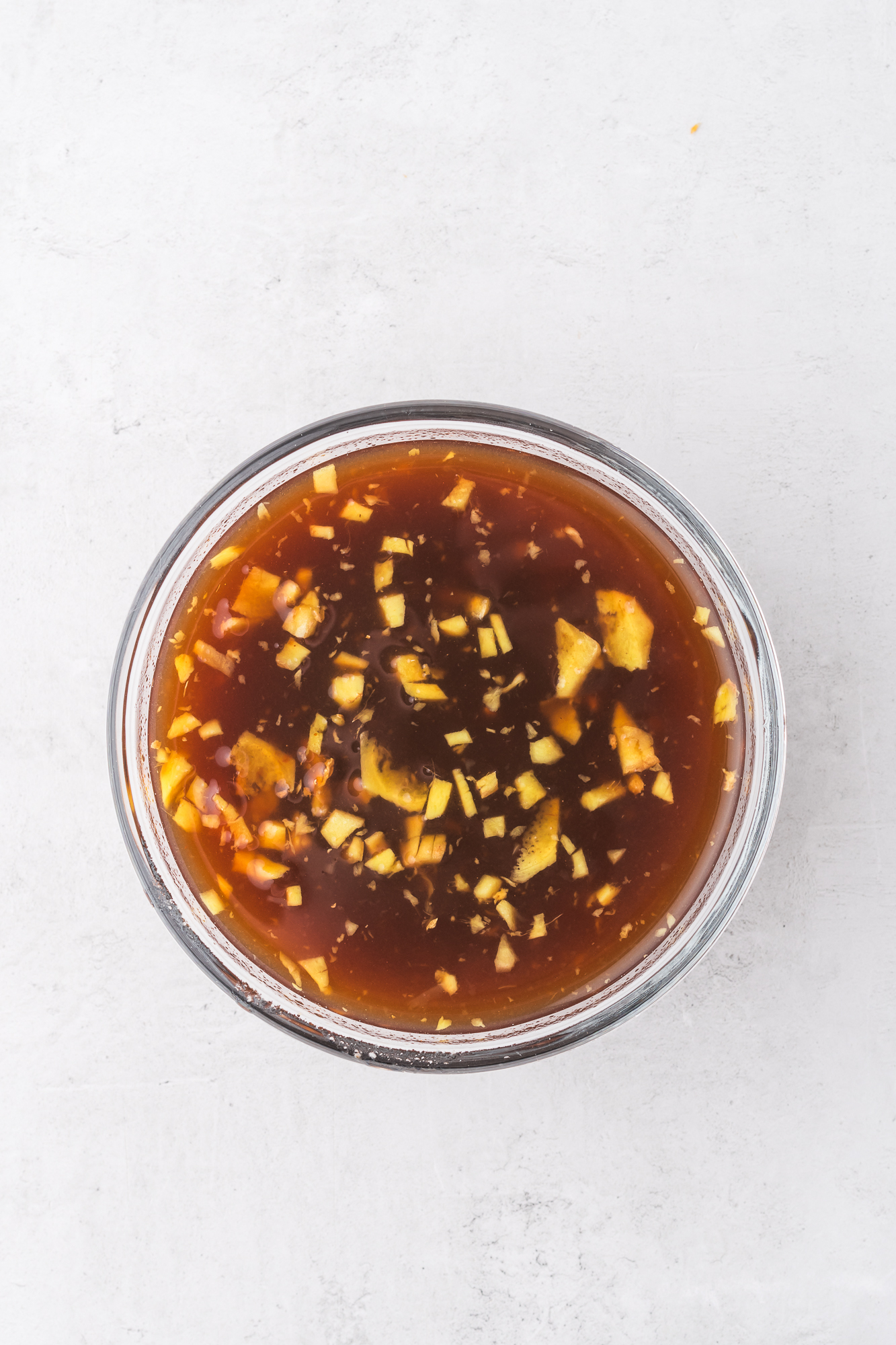 A glass bowl of the sauce for Slow Cooker Hawaiian Chicken.