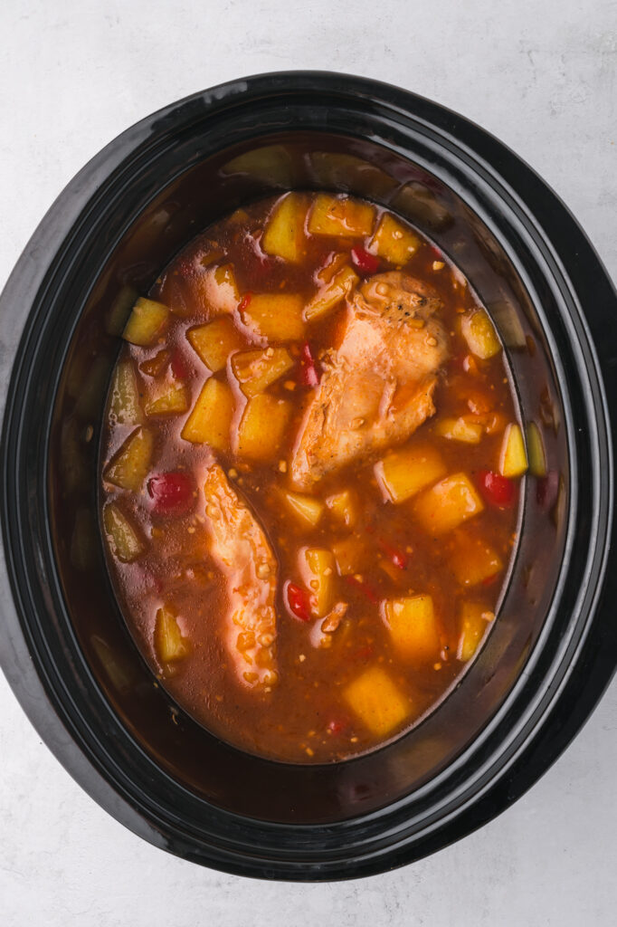 A slow cooker of cooked Slow Cooker Hawaiian Chicken.